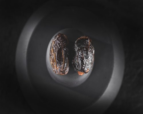 Close-up comparison showing fresh dates next to naturally dried dates